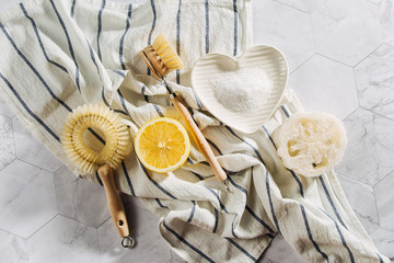 Eco friendly natural cleaning tools and products, bamboo dish brushes and lemon with baking soda....