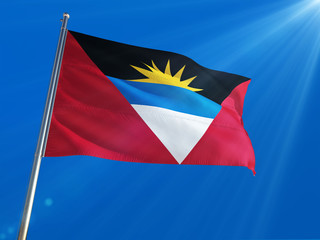 Antigua and Barbuda National Flag Waving on pole against deep blue sky background. High Definition