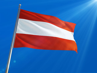 Austria National Flag Waving on pole against deep blue sky background. High Definition