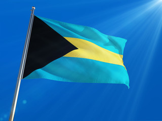 Bahamas National Flag Waving on pole against deep blue sky background. High Definition