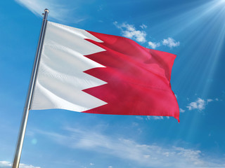 Bahrain National Flag Waving on pole against sunny blue sky background. High Definition