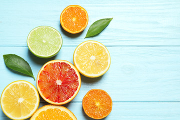 Flat lay composition with different citrus fruits and space for text on wooden background