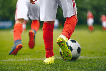 Football/Soccer Running with the Ball. Soccer Player Training on the Field. Close-up View of Soccer...