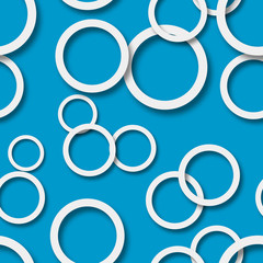 Abstract seamless pattern of randomly arranged white rings with soft shadows on light blue background