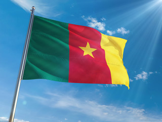 Cameroon National Flag Waving on pole against sunny blue sky background. High Definition