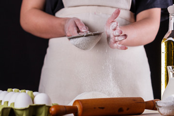 young woman squirting a flour in an apron