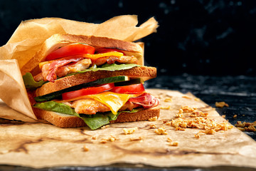 Freshly made clubsandwiches served on a wooden chopping board
