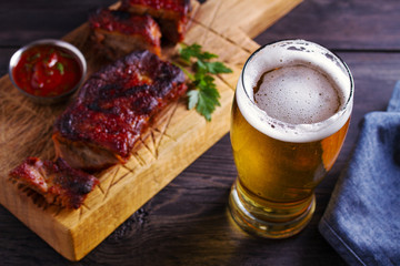 Beer and pork spare ribs. Beer and meat. Glass of ale