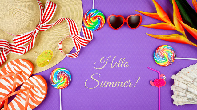 Summer vacation theme flatlay overhead with sunhat, lollipops, ice creams and sunglasses on purple background, with text gretting.
