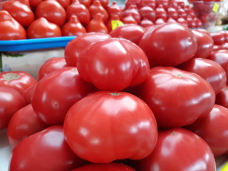 Ripe red tomatoes closeup on the market, fresh tomatoes