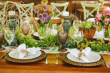 Wedding Setup. Banquet with table and chairs. Decoration, flowers, ware, glass