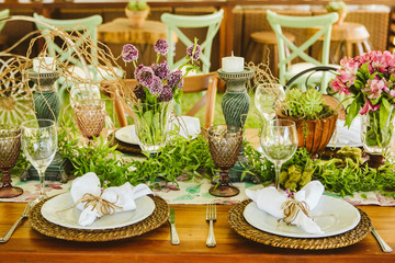 Wedding Setup. Banquet with table and chairs. Decoration, flowers, ware, glass