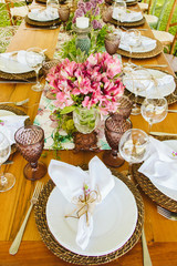 Wedding Setup. Banquet with table and chairs. Decoration, flowers, ware, glass