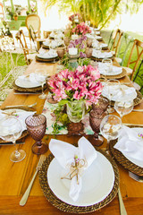 Wedding Setup. Banquet with table and chairs. Decoration, flowers, ware, glass