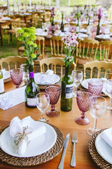 Wedding Setup. Banquet with table and chairs. Decoration, flowers, ware, glass