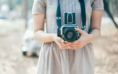 Vintage camera on woman hand with vintage mood