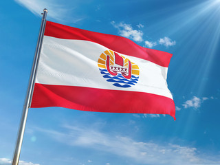 French Polynesia National Flag Waving on pole against sunny blue sky background. High Definition