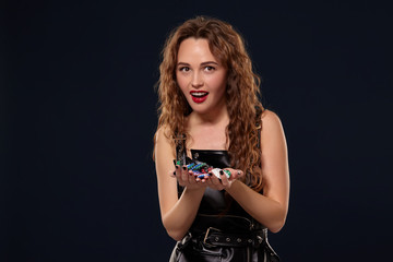 Casino concept. Portrait of young pretty caucasian woman, playing in casino. Roulette, poker chips, cards, wheel, isolated white background