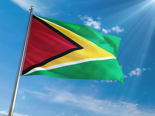 Guyana National Flag Waving on pole against sunny blue sky background. High Definition
