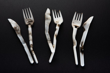 Plastic utensils, Forks, spoons, knives. Picnic dishes. not eco-friendly plastic. Environmental protection.
