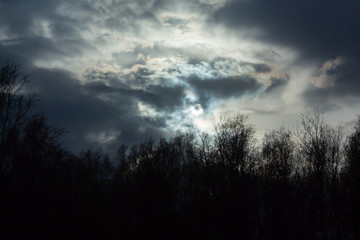 dark sun among the clouds
