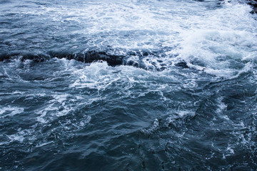 Dark blue nothern ocean waves in winter. Water surface
