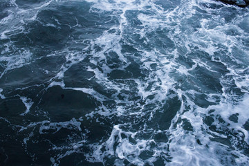 Fototapeta na wymiar Dark blue nothern ocean waves in winter. Water surface