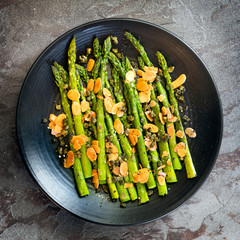 Roasted Asparagus with Toasted Almonds and Capers Top View on Slate