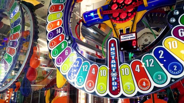 4k footage of colorful round display at slot machine in amusement park