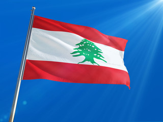 Naklejka na ściany i meble Lebanon National Flag Waving on pole against deep blue sky background. High Definition