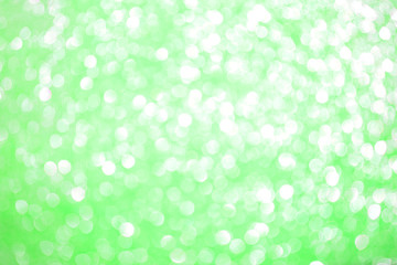 Bokeh blurred green background, Christmas and New Year holidays background. Party concept. Festive holiday card bright backdrop. Defocused. Flat lay, top view, copy space.
