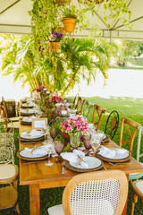 Wedding Setup. Banquet with table and chairs. Decoration, flowers, ware, glass