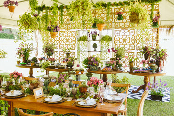 Wedding Setup. Banquet with table and chairs and cake tables with sweet. Decoration, flowers, ware, glass