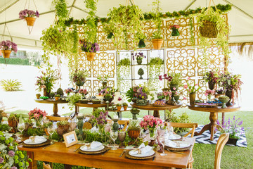 Wedding Setup. Banquet with table and chairs and cake tables with sweet. Decoration, flowers, ware, glass