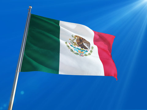 Mexico National Flag Waving on pole against deep blue sky background. High Definition