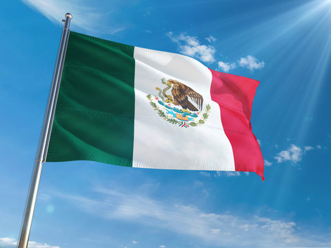 Mexico National Flag Waving on pole against sunny blue sky background. High Definition