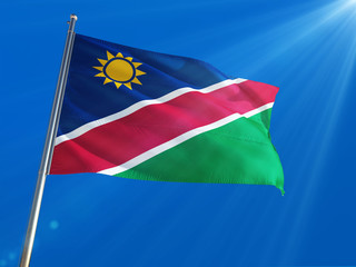 Namibia National Flag Waving on pole against deep blue sky background. High Definition