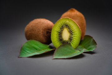 Fresh kiwi with leaves. On black background