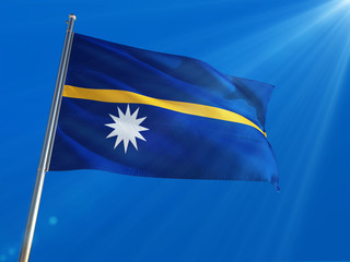 Nauru National Flag Waving on pole against deep blue sky background. High Definition