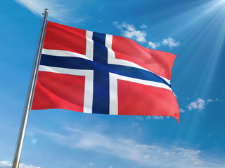 Norway National Flag Waving on pole against sunny blue sky background. High Definition