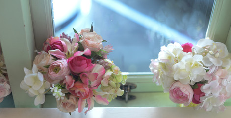 Flowers for decorating in weddings, elegantly arranged on the dining table by the window, beautiful natural light