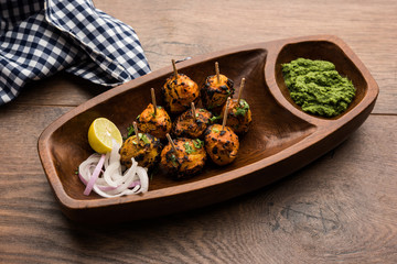 Tandoori aloo are roasted potatoes with Indian spices. It's a party appetiser served with green chutney. selective focus