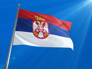 Fototapeta na wymiar Serbia National Flag Waving on pole against deep blue sky background. High Definition