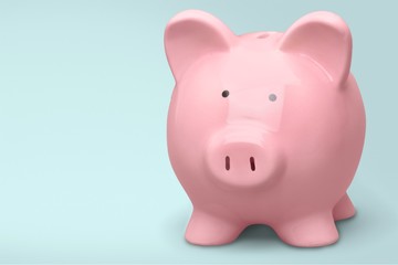 Man putting coin in pig moneybox