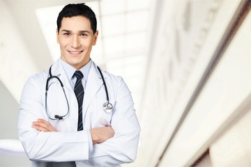 Young beautiful nurse on blurred hospital background