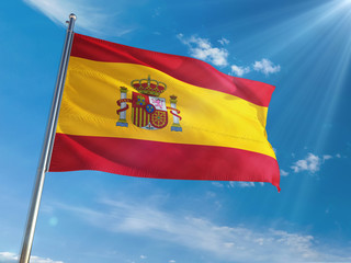 Spain National Flag Waving on pole against sunny blue sky background. High Definition