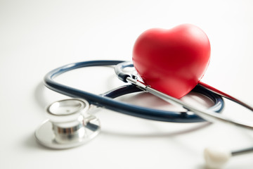 Red heart with stethoscope on white background