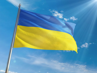 Ukraine National Flag Waving on pole against sunny blue sky background. High Definition