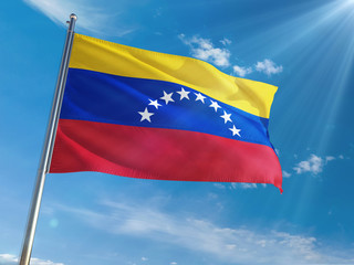 Venezuela National Flag Waving on pole against sunny blue sky background. High Definition