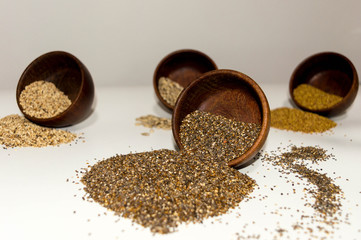  Containers with seeds spilled on the table.